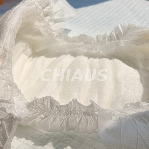 Close-up of gathered elastic leg cuffs and nonwoven topsheet on adult briefs