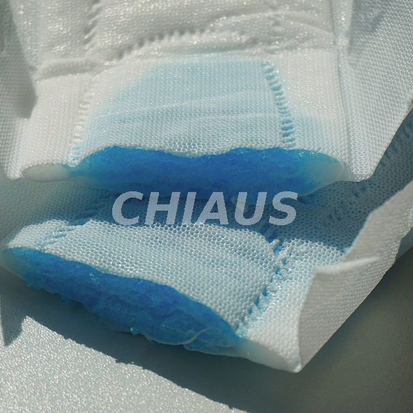 Cross-Section of a Sanitary Pad Showing Blue Test Liquid in the Absorbent Core 