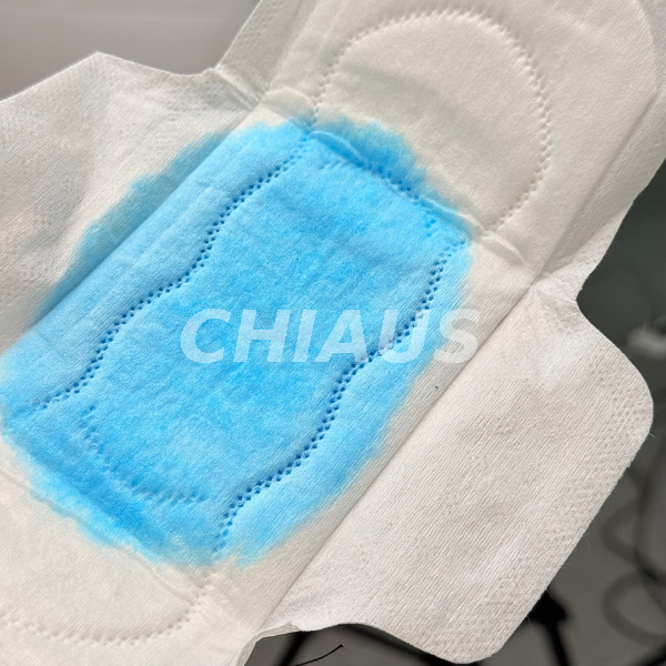Blue Liquid Absorption Demonstration on a Sanitary Pad Absorbent Core 